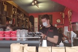 A man pours a coffee at a coffee machine