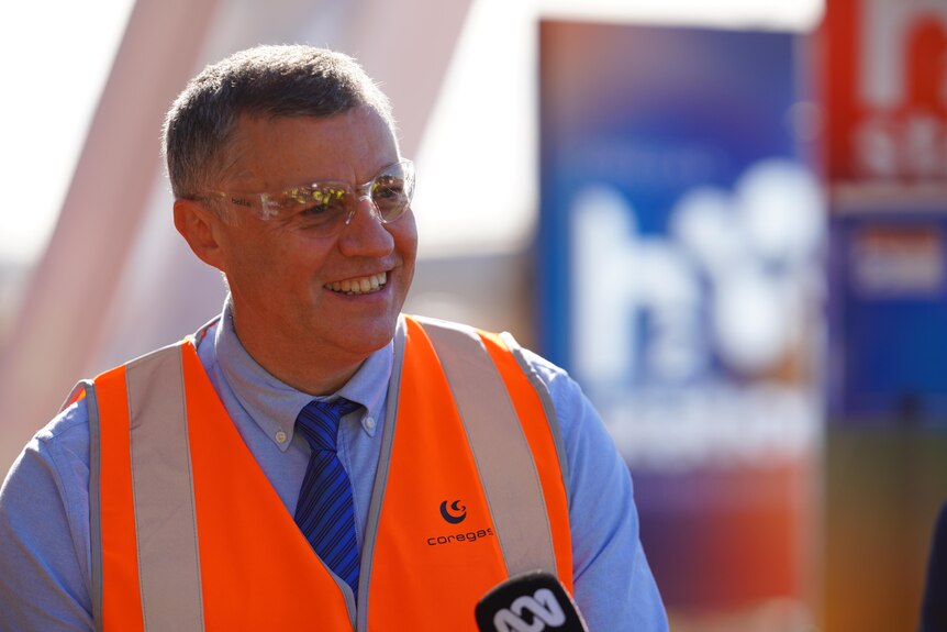 Man smiling wearing highvis and protective glasses 