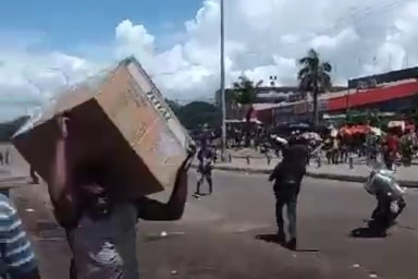 People walk through the streets with boxes