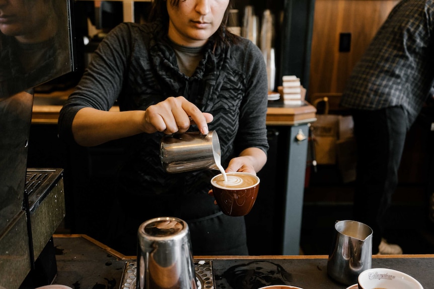 A barista making coffee