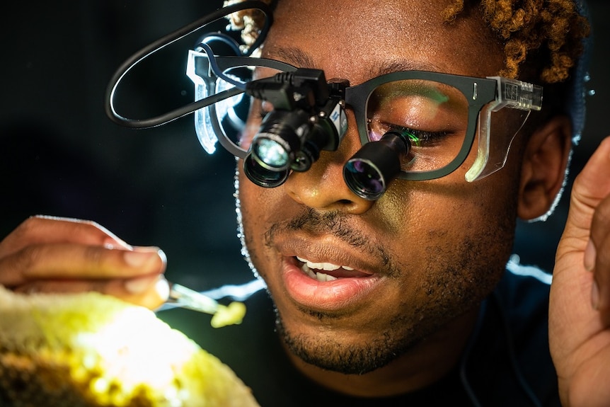 Close up of scientists face with microscopic goggles