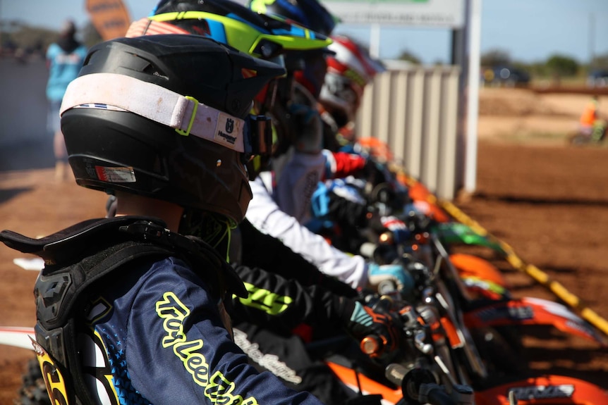 Junior motorcross riders at the start line