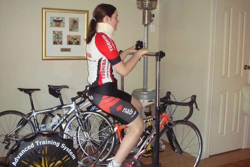 Anna Meares sits facing the right side of the photo with a neck brace on.