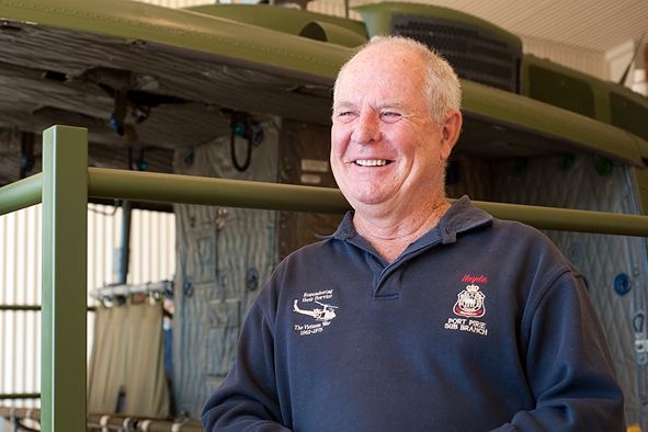Veteran Haydn Madigan stands in front of the helicopter at the Port Pirie RSL