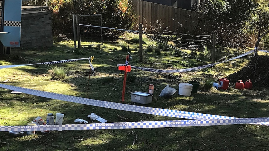 Crime scene tape in the backyard of a Hobart house