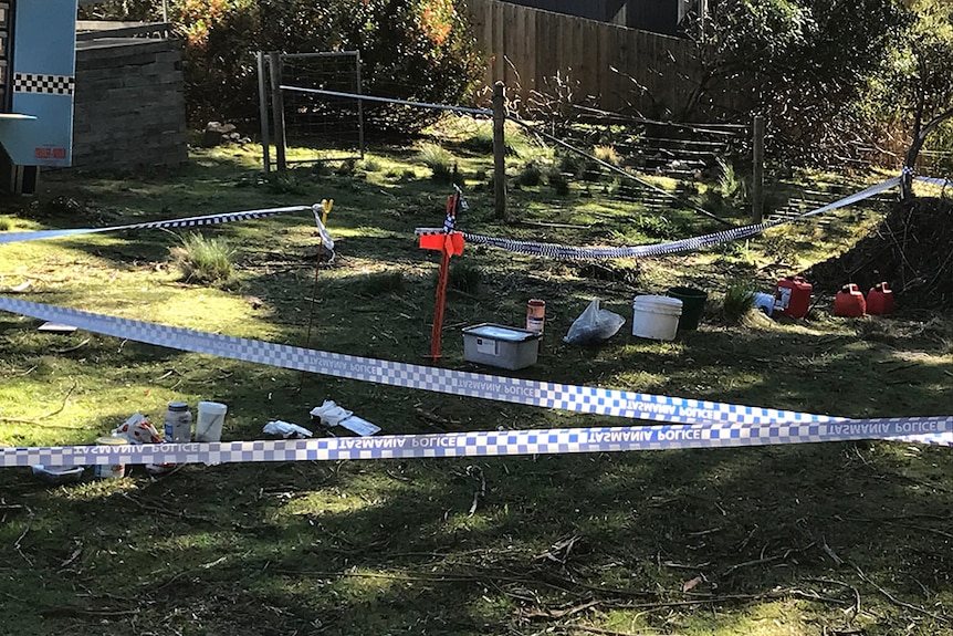 Crime scene tape in the backyard of a Hobart house