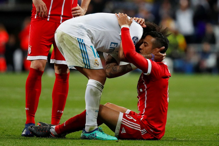 Real Madrid's Marcelo (L) and Bayern Munich's Thiago Alcantara embrace after the full-time whistle.