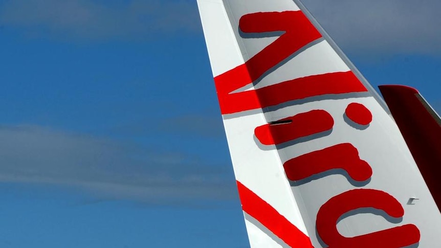 Two planes sport the new branding for the Virgin Australia airline on the tarmac at Sydney Airport