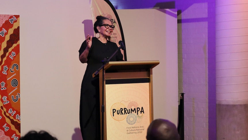 Aboriginal woman Francesca Cubillo speaks at podium for Purrumpa festival