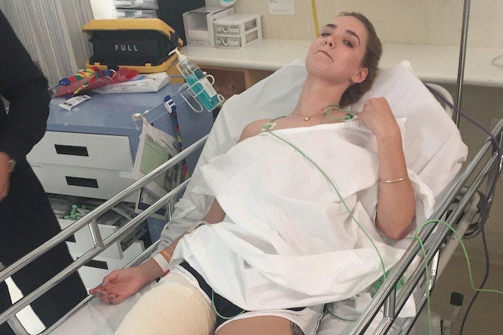 Jorji Harper lays on a hospital bed at at Joondalup Health Campus with her leg in a splint.