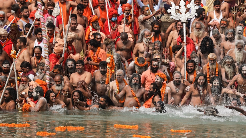 Hindu holy men take holy dips in the Ganges River