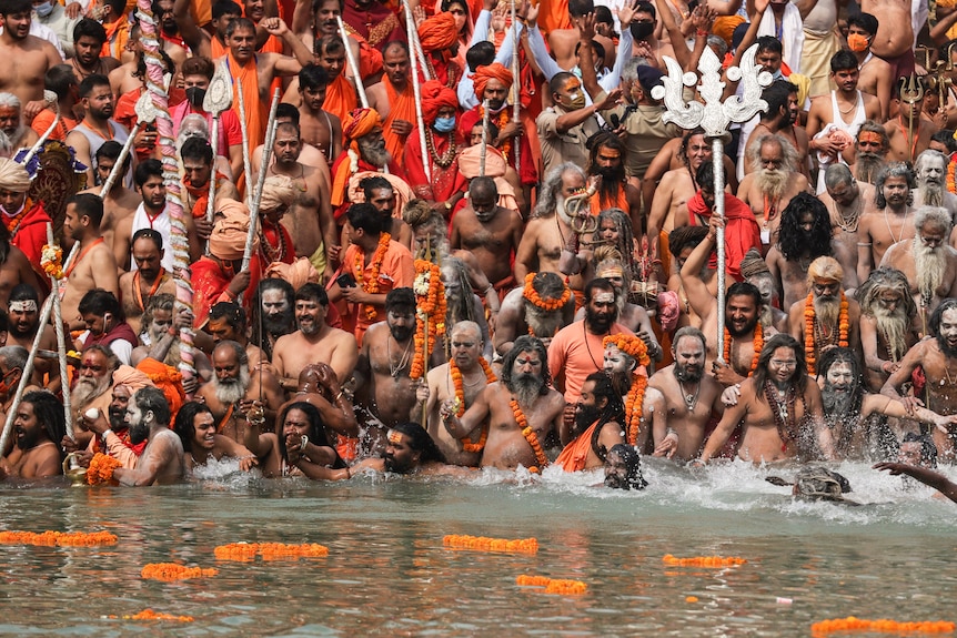 Hindu holy men take holy dips in the Ganges River