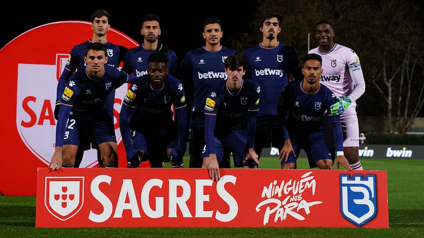 Nine players pose for a pre-match team photo