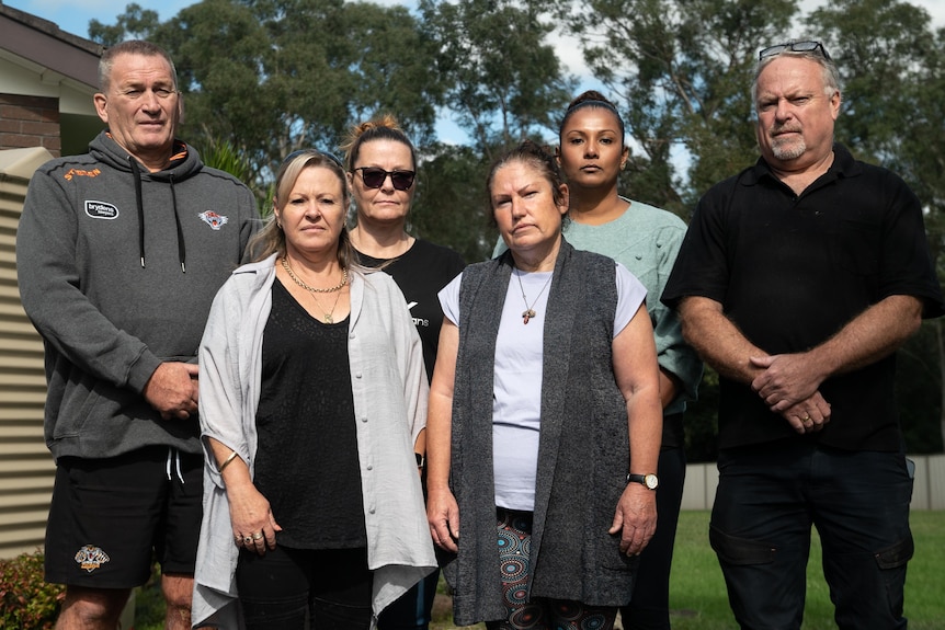 A group of six people looking at the camera, with angry expressions.