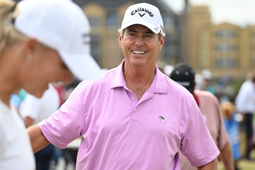 Ian Baker-Finch smiles while talking on a golf course