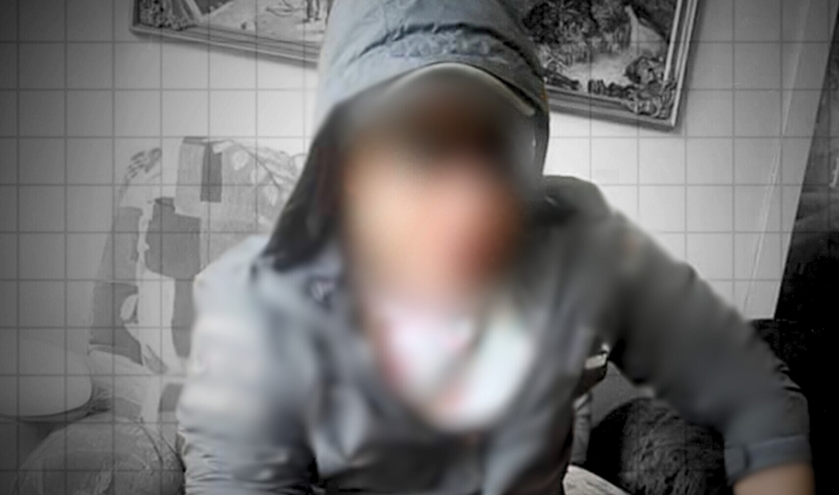 Man wears a grey hooded jumper. His face is blurred out and unrecognisable 