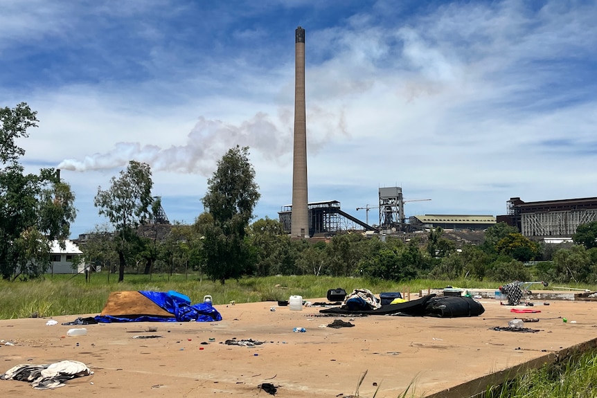 Deflated tents and rubbish strewn around a makeshift campsite in Mount Isa