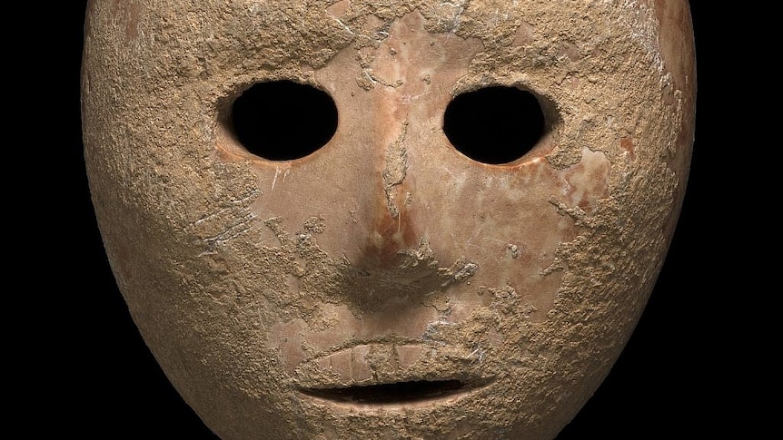 A close-up of a mask with a black background