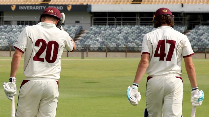 Queensland batsmen Michael Neser and Sam Heazlett enter the field of play during a Sheffield Shield match.