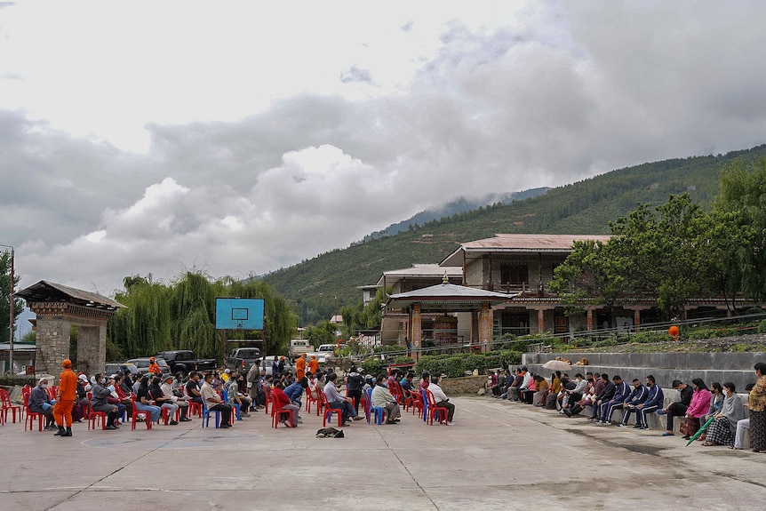 People line up outdoors in Thimpu to get their COVID vaccine on July 20, 2021. 