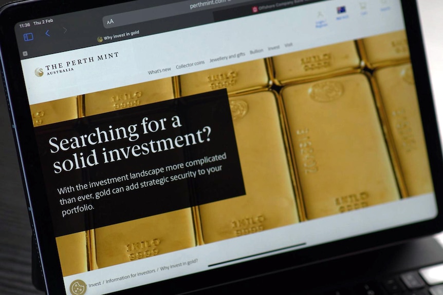 A laptop showing the Perth Mint website. It has a background of gold bars and the heading "searching for a solid investment?"