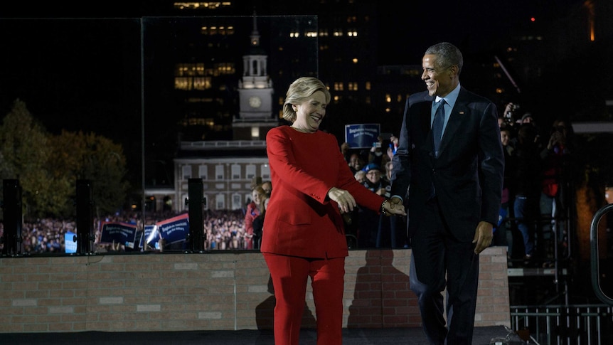 Hilary Clinton and Barack Obama walking side-by-side.