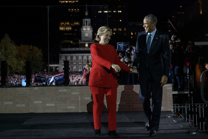 Hilary Clinton and Barack Obama walking side-by-side.