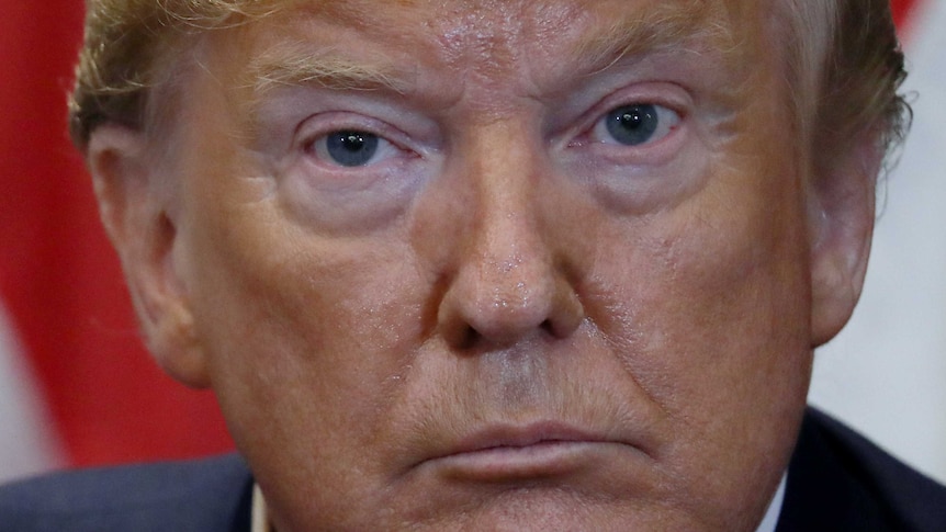 A very close shot of Donald Trump's face as he stares intensively.