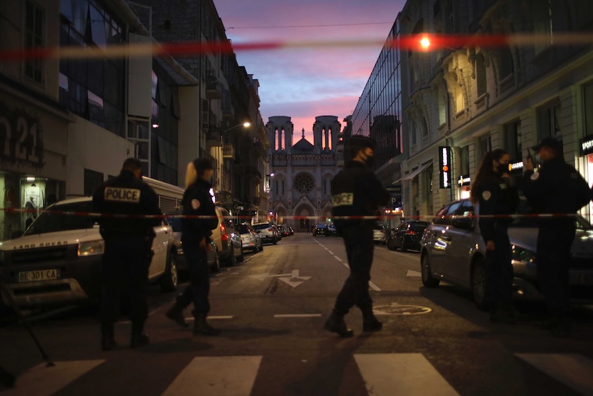 Police work behind a restricted zone near the Notre Dame church in Nice, France.