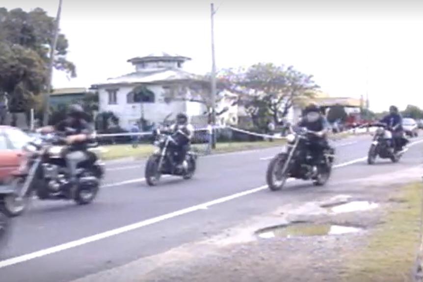 A group of bikies riding away from the scene of a shootout in Mackay.