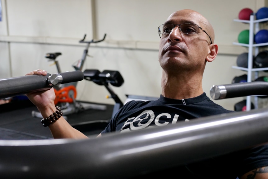 Travis Toar works out on a gym machine