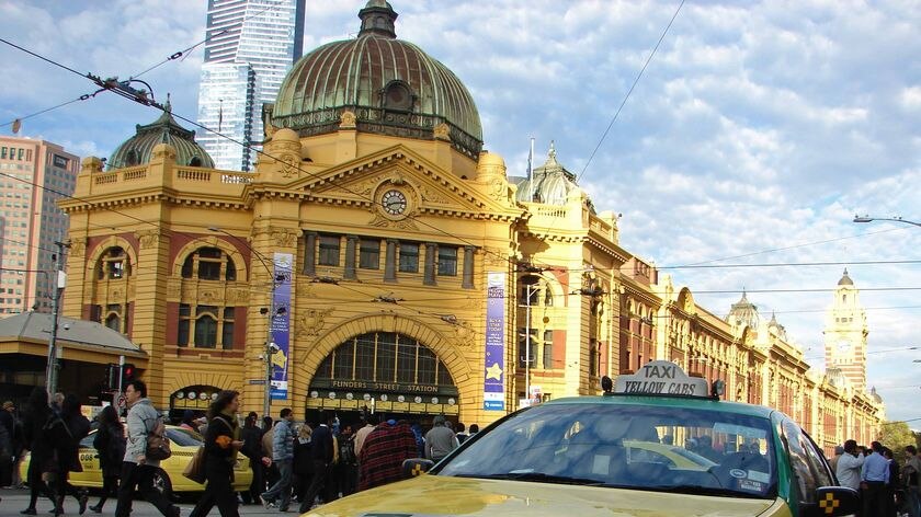Angry taxi drivers gather outside Melbourne's Flinders Street station