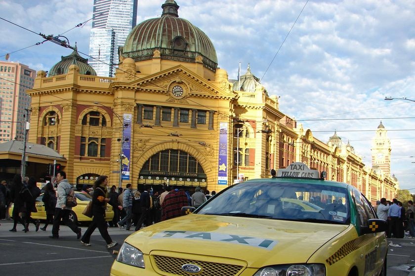 Angry taxi drivers gather outside Melbourne's Flinders Street station