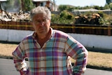 Graeme Wells (neighbour) standing in front of demolished house in Mt Stuart.