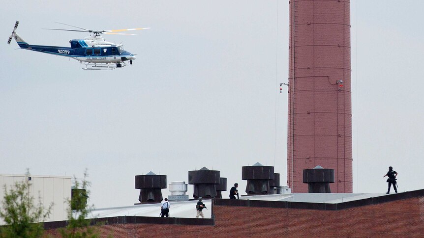 Police helicopter flies near Washington Navy Yard shooting.