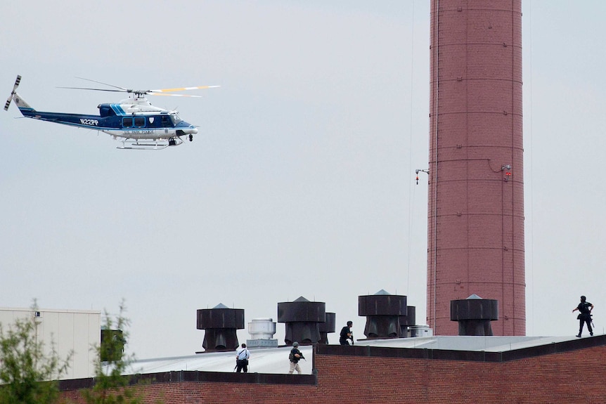 Police helicopter flies near Washington Navy Yard shooting.