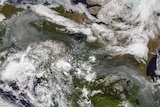 Almost a continuous string of wildfire smoke from Alaska over Canada shown on a satellite image.