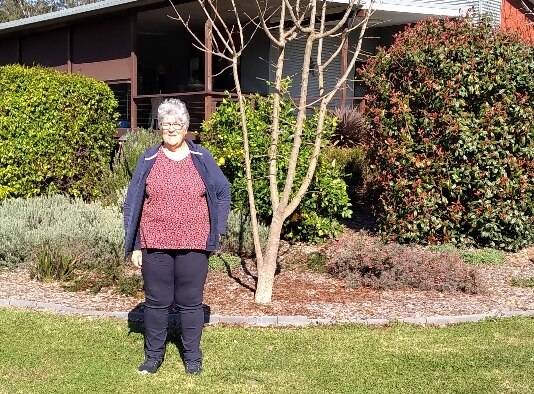 woman in front of house