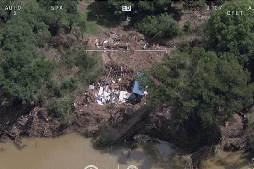 aerial image of large amount of rubbish near river