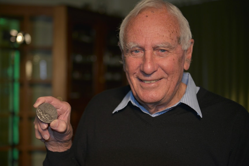 Olympian Leon Gregory with his medal from 1956.