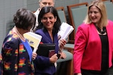 Julia Banks smiles as she speaks to colleagues.
