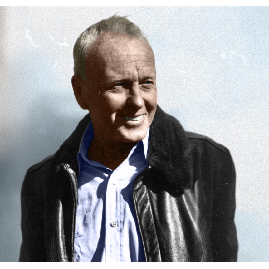 An old hand coloured photograph of a man in a black forties bomber jacket