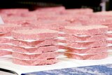 Neat piles of pink patties made by Impossible Foods and sold at Burger King in the United States