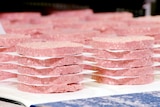 Neat piles of pink patties made by Impossible Foods and sold at Burger King in the United States