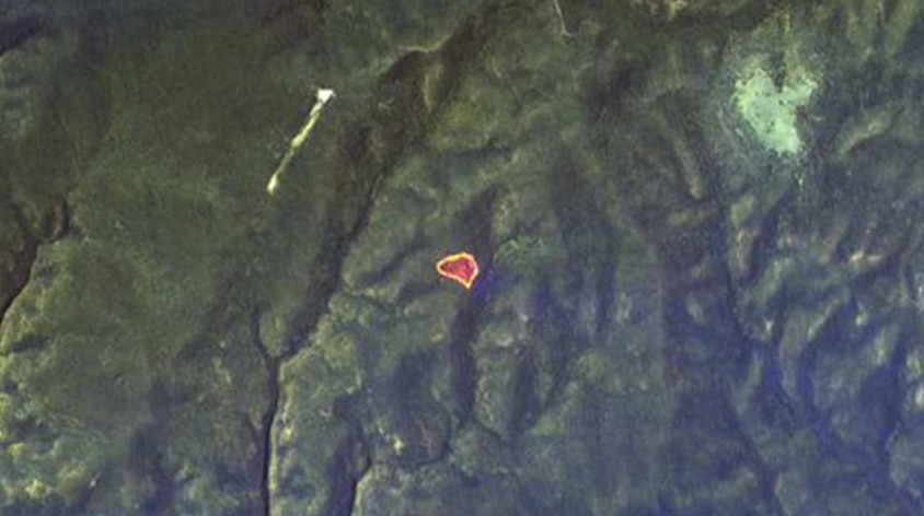 A small dot on a large map, seen from above