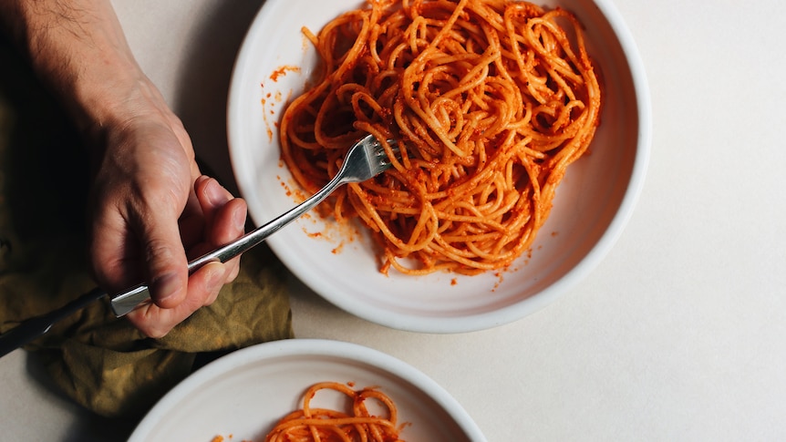 Two bowls of red pesto pasta made with sundried tomato and jarred capsicum, an easy meal perfect for weeknights and families.