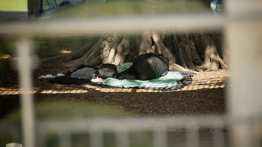 A homeless person sleeps in a Brisbane park
