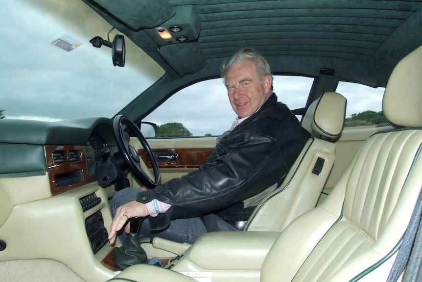 David Terrence Holt sits in a car.