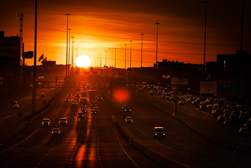 An aerial view of a large freeway at sunset.