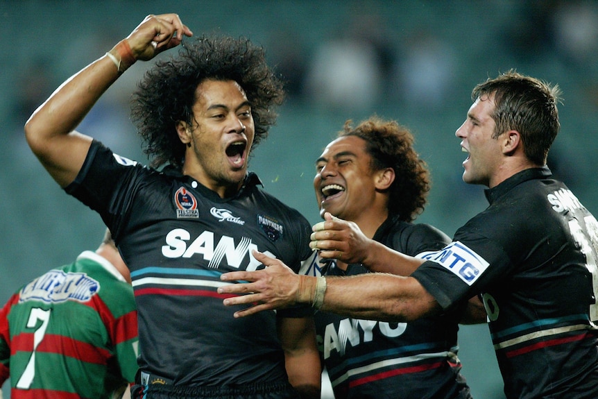 A man celebrates a try during a rugby league match